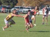 North Wagga's Jackson Kerr looks to escape East Wagga-Kooringal's Dylan Morton in the Farrer League game at McPherson Oval on Saturday. Picture by Matt Malone