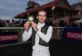Tyler Schiller shows off the Tye Angland Medal for the leading rider over the two big days of the Wagga Gold Cup carnival. Picture by Les Smith