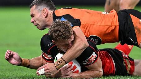 Wests Tigers centre Brent Naden hits Dolphins winger Jack Bostock in the head with his forearm. (Dave Hunt/AAP PHOTOS)