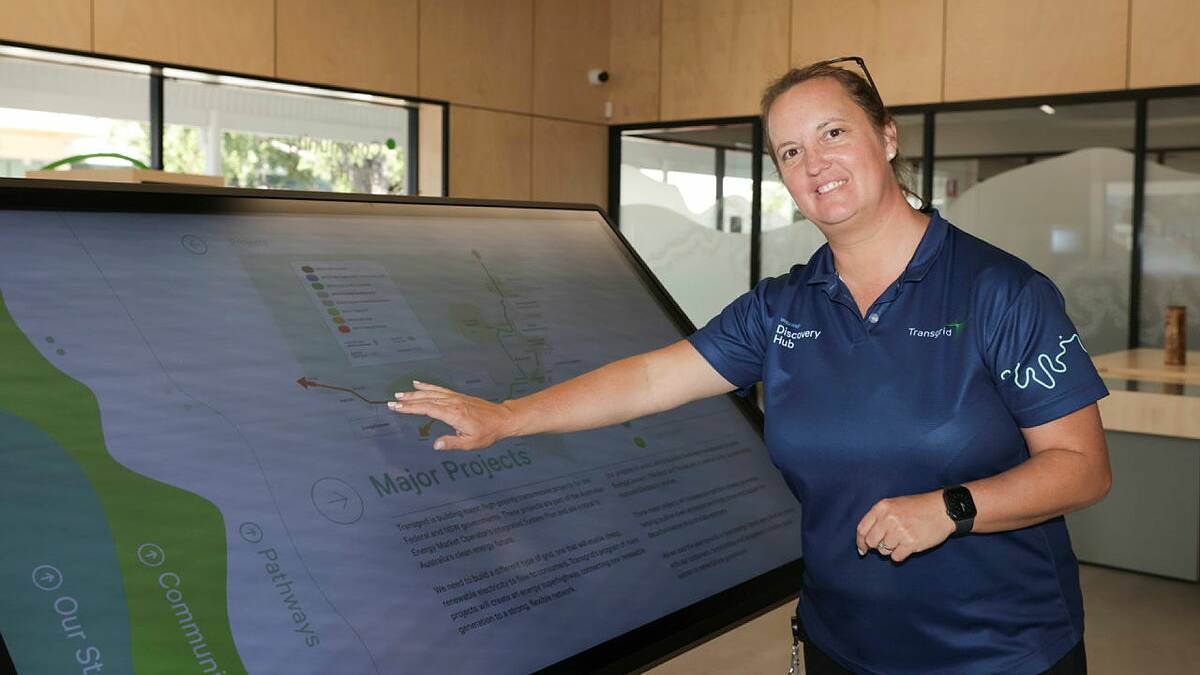 Transgrid's community stakeholder and engagement lead Rebecca Peel demonstrates an interactive panel designed to help the public find more out about major energy infrastructure projects across the region. Picture by Tom Dennis