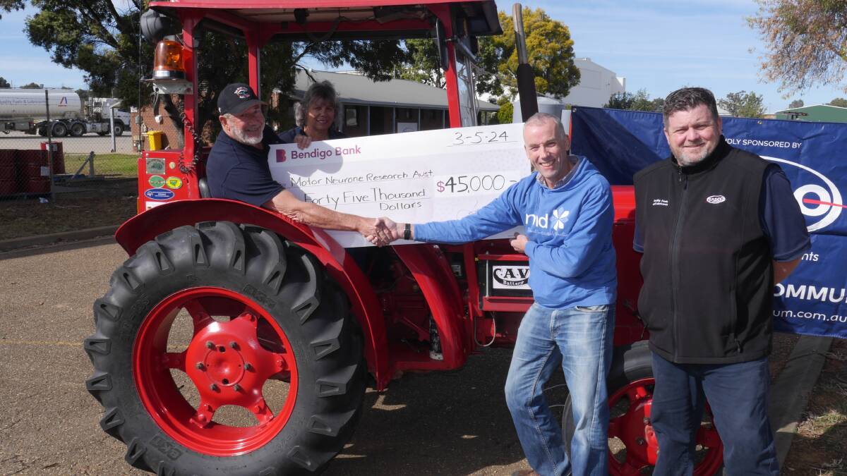 Neil and Robyn Cole deliver a cheque of $45,000 to Research MND Australia's Gethin Thomas at the Tasco Petroleum Wagga depot on Friday. Depot manager Matthew Tansey was also present. Picture by Andrew Mangelsdorf