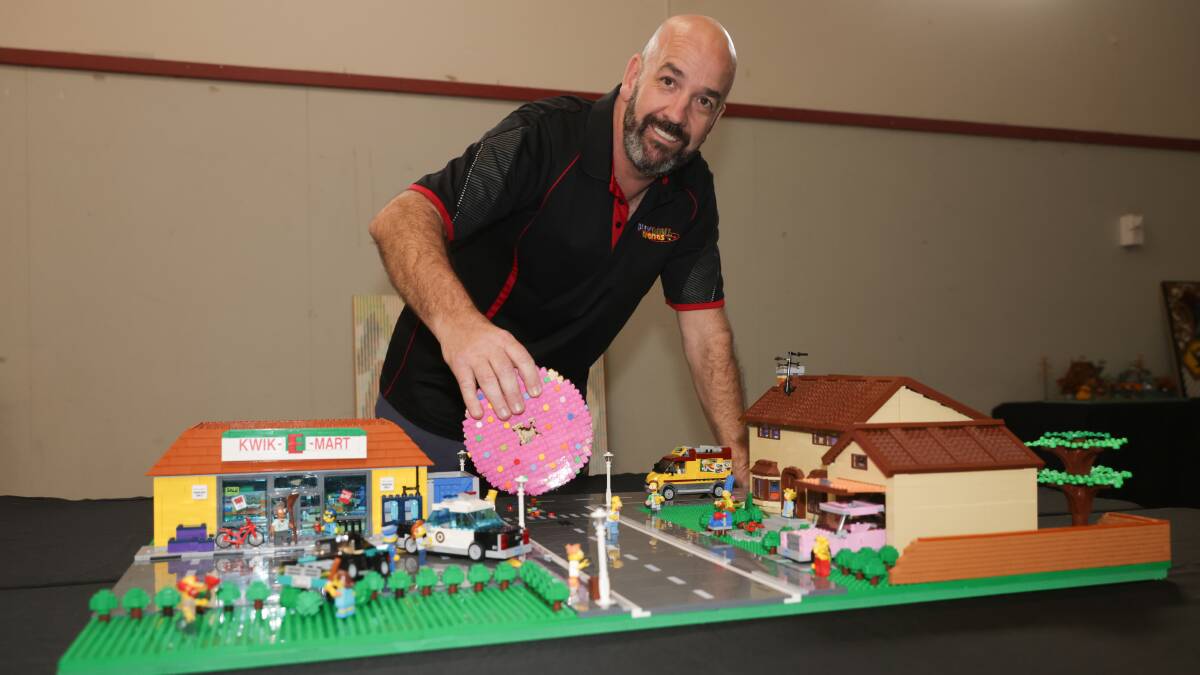 Wagga Brick Show, Graham Draper puts in the finishing touches to his Simpsons display as he readies to open the doors of the Kyeamba Smith Hall on Saturday morning. Picture by Tom Dennis