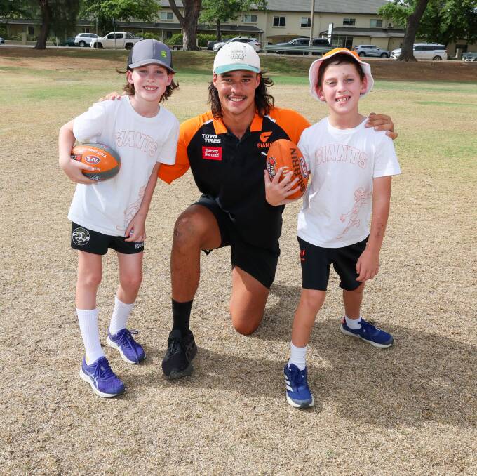 GWS Giants ruckman Nick Madden with Wagga brothers Lachlan Glazier, 9 and Patrick Glazier, 8 at the footy clinic run by AFL Riverina on Thursday. Picture by Les Smith