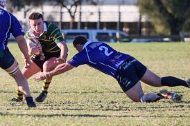 Ag College's Jackson Buda attempts to evade the incoming tackle from Waratahs' Angus Burns during their clash at Beres Ellwood Oval. Picture by Les Smith
