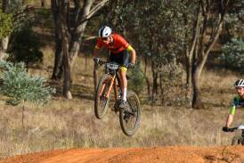Canberra ORC's Eddie Mungoven gets some air during his race at the AusCycling Marathon National Championships held at Pomingalarna Mountain Bike Park. Picture by Bernard Humphreys
