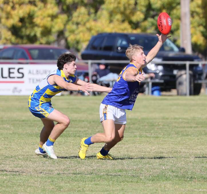 Narrandera's Harvey Odgers grabs the footy ahead of MCUE's Harrison Wheeler during the clash between the Goannas and Eagles at Mangoplah Sportsground on Saturday. Picture by Les Smith
