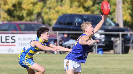 Narrandera's Harvey Odgers grabs the footy ahead of MCUE's Harrison Wheeler during the clash between the Goannas and Eagles at Mangoplah Sportsground on Saturday. Picture by Les Smith