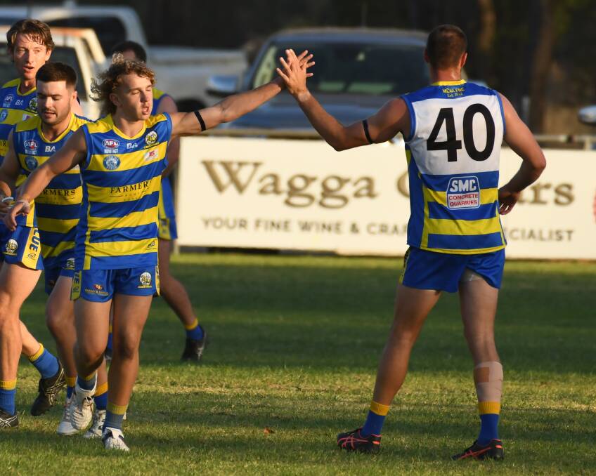 MCUE teenage forward Jack Warden high-fives Dean Lord after one of his opening-term goals at Mangoplah Sportsground on Good Friday. Picture by Bernard Humphreys