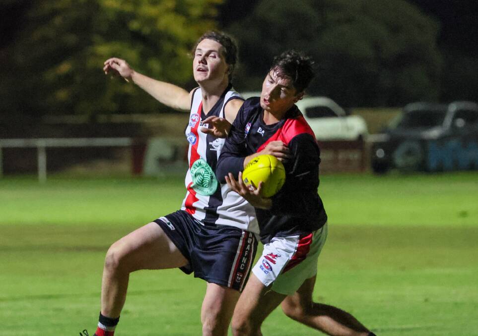 Marrar forward Blake Walker takes a nice grab while under pressure from North Wagga's Isaac Bennett during the Thursday night clash between the Saints and Bombers. Picture by Les Smith