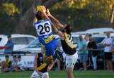 MCUE defender Lachie Johnson flies high in a marking attempt during the Good Friday season-opener at Mangoplah Sportsground. Picture by Bernard Humphreys