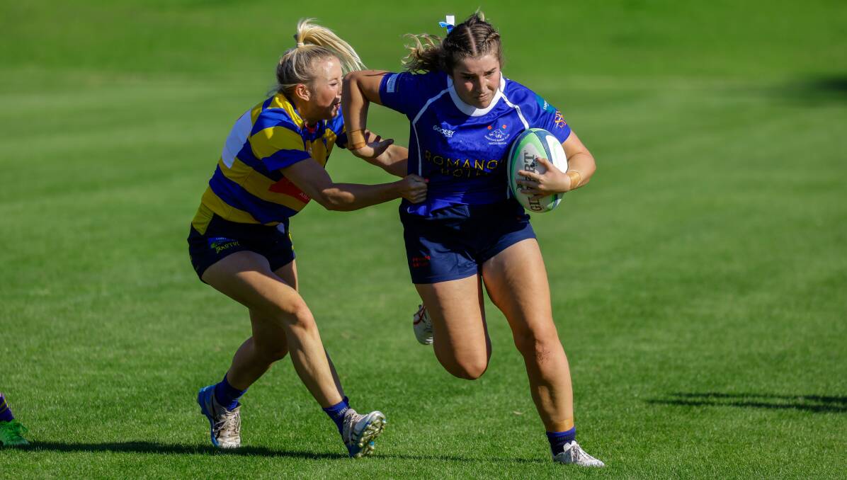 Waratahs player Milly Lucas pushes through the Steamers defence. Picture by Bernard Humphreys