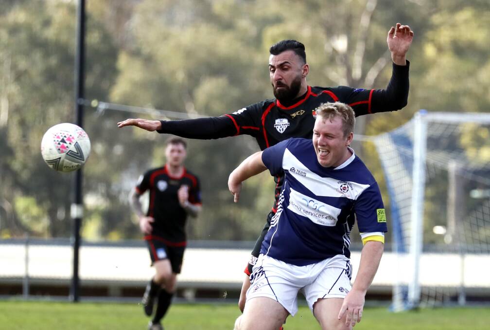 Incoming Young coach Duncan Cameron blocks Leeton United's Henri Gardner during the 2022 season. Picture by Les Smith