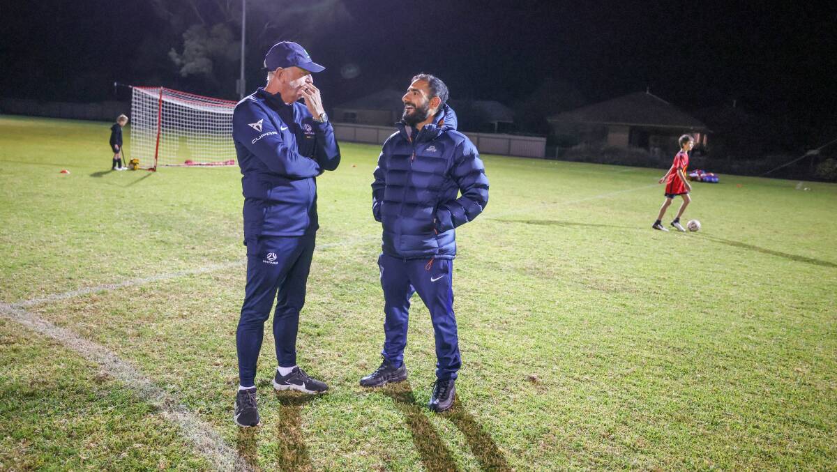 Tolland coach Ahmed Al-Rubie speaks with Socceroos coach Graham Arnold. Picture by Les Smith