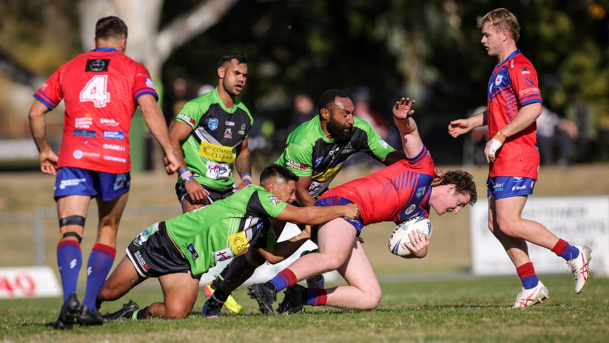 Albury's Frederick Wells and Jackins Olam tackle Kangaroos' Ned Cooper. Picture by James Wiltshire. 