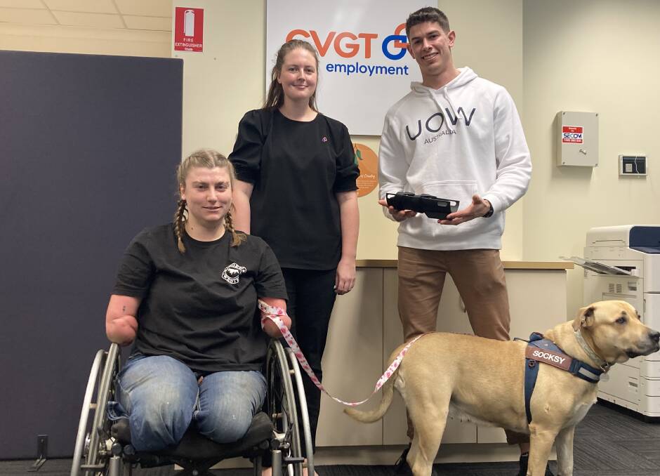 Grace with her assistance dog Socksy, CVGT Employment Consultant Tegan McKenzie and University of Wollongong student Charles Crisp at the Wagga CVGT Employment office. Picture by the University of Wollongong