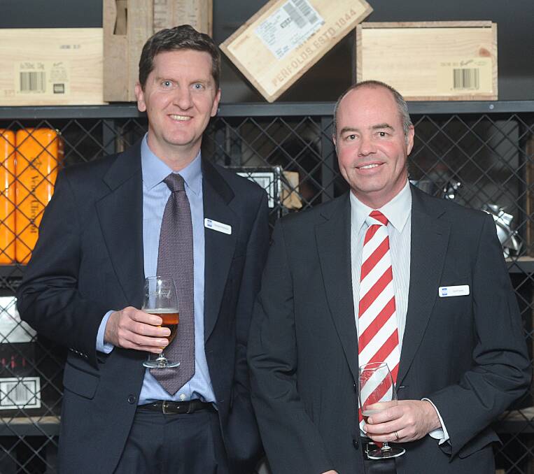 Reuben Robinson and Scott Farrell, both of GHD, celebrate the company's 10th anniversary on Thursday evening. 