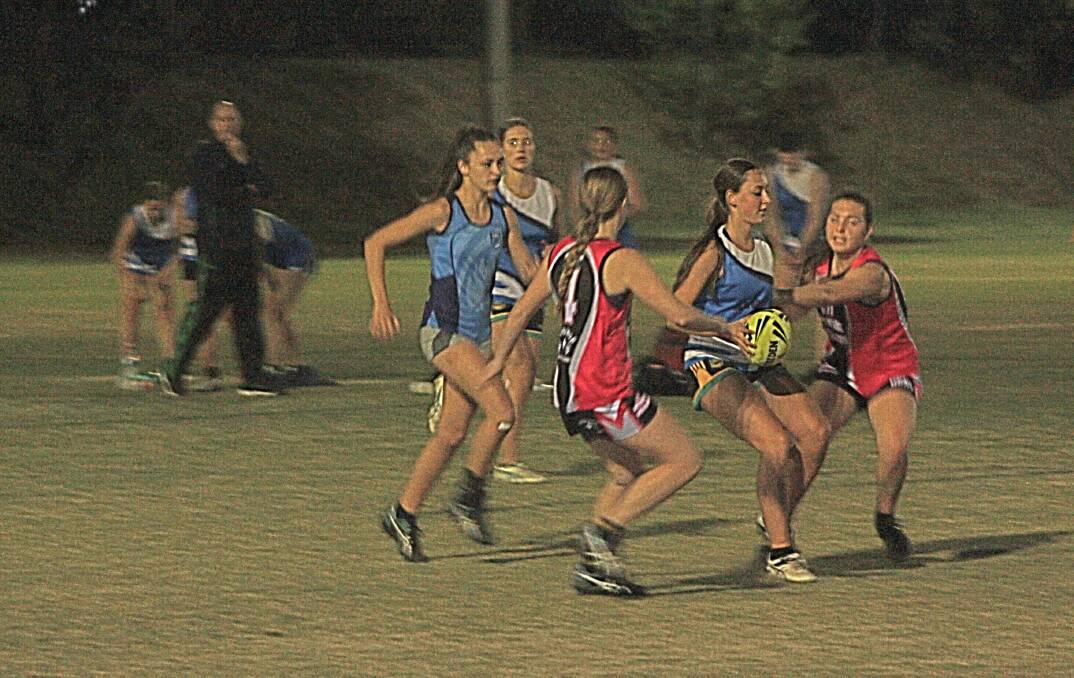 SURROUNDED: AKW Jets' Abbey Corbett is pulled up during her side's confidence boosting win over Young Guns at Jubilee Park on Tuesday night. 