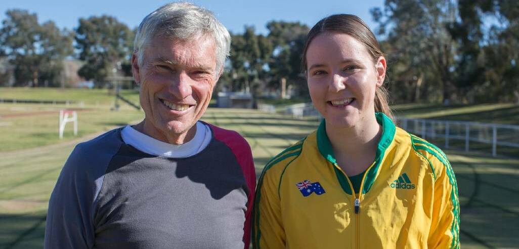  Wagga athlete Carly Salmon shows off her Australian colours with coach Mark Conyers.
