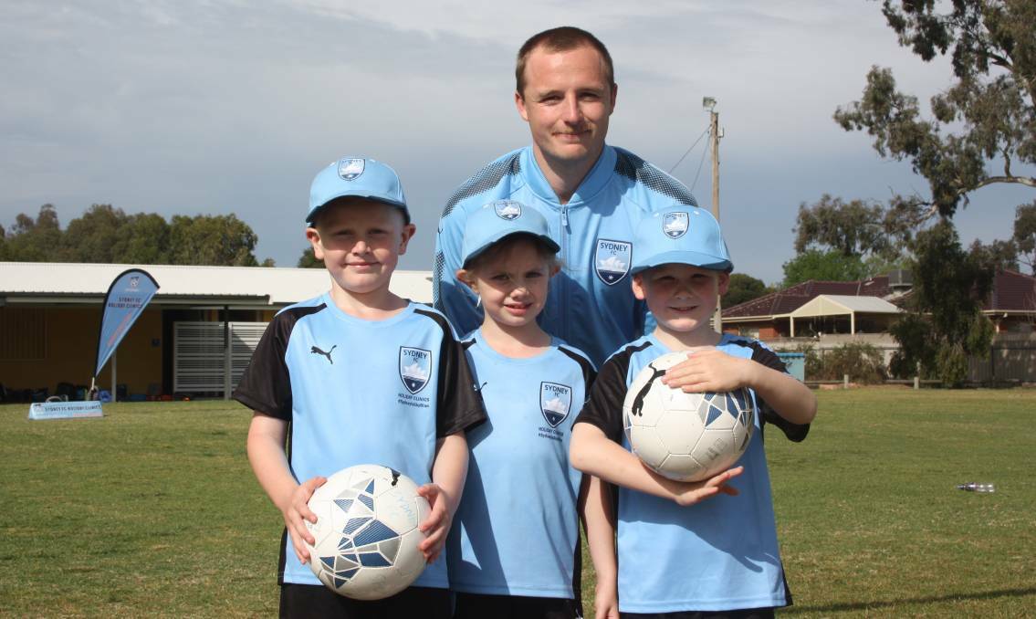 Sydney FC defender Rhyan Grant with Wagga's Daniel Robert, 6, Olivia McLenan, 7, and Bailey Ingold, 6, at Rawlings Park in October. 