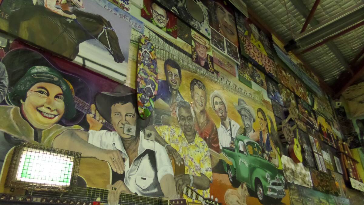 Artwork created by inmates stretching from floor to ceiling inside the Correctional Centre's cultural centre. 