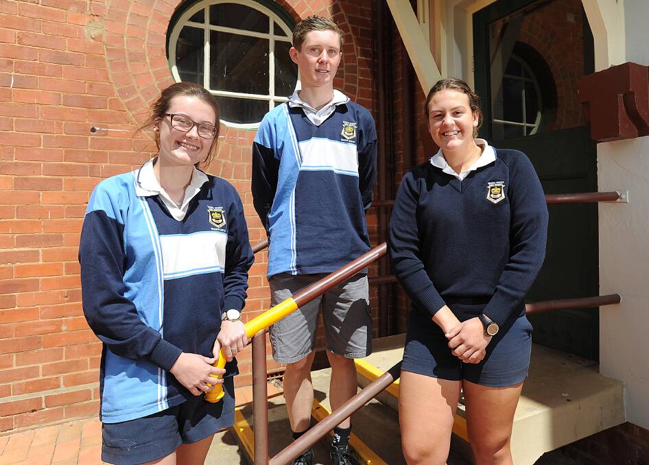 APPROACHING THE FINISH LINE: Wagga High School students Claudia Jenkins, Callum Clayton and Isobel Cowell enjoy relief and sunshine following their first HSC exam. 