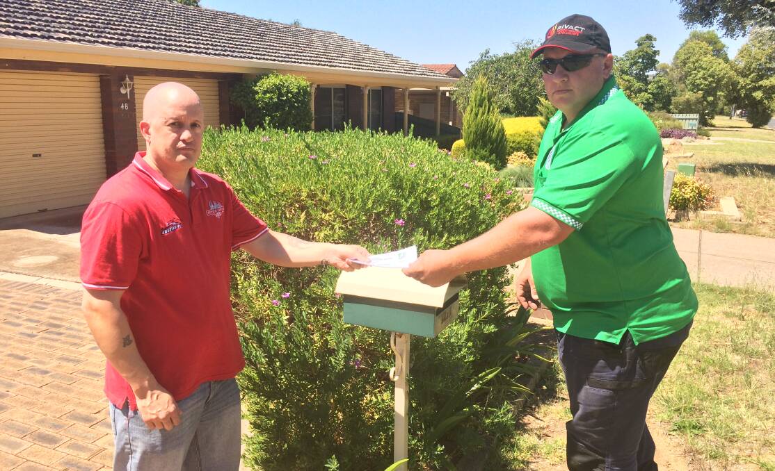 AWARENESS CAMPAIGN: Neighbourhood Watch Wagga president Wayne Deaner drops a home safety pamphlet to Glenfield Park resident Jason Le Cram. 