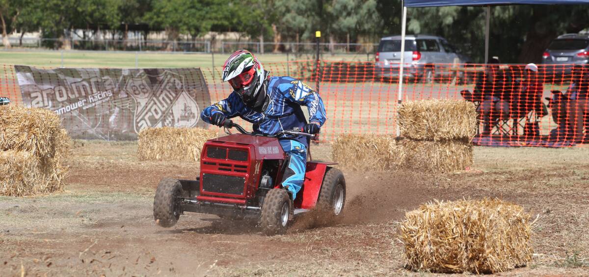 MOWING DOWN THE MILES: Number 14 James Roser on track at Griffith's inaugural lawn mower racing championships for Cystic Fibrosis. PHOTO: Anthony Stipo.
