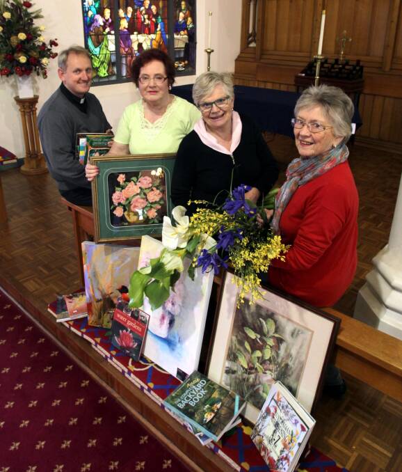 PRECIOUS BLOOMS: Rector of St John's, the venerable David Ruthven, with volunteers Linda Pelletier, Janice Vrolyks and Val Garthon ahead of the Festival of Flowers, Music and Art. Picture: Les Smith