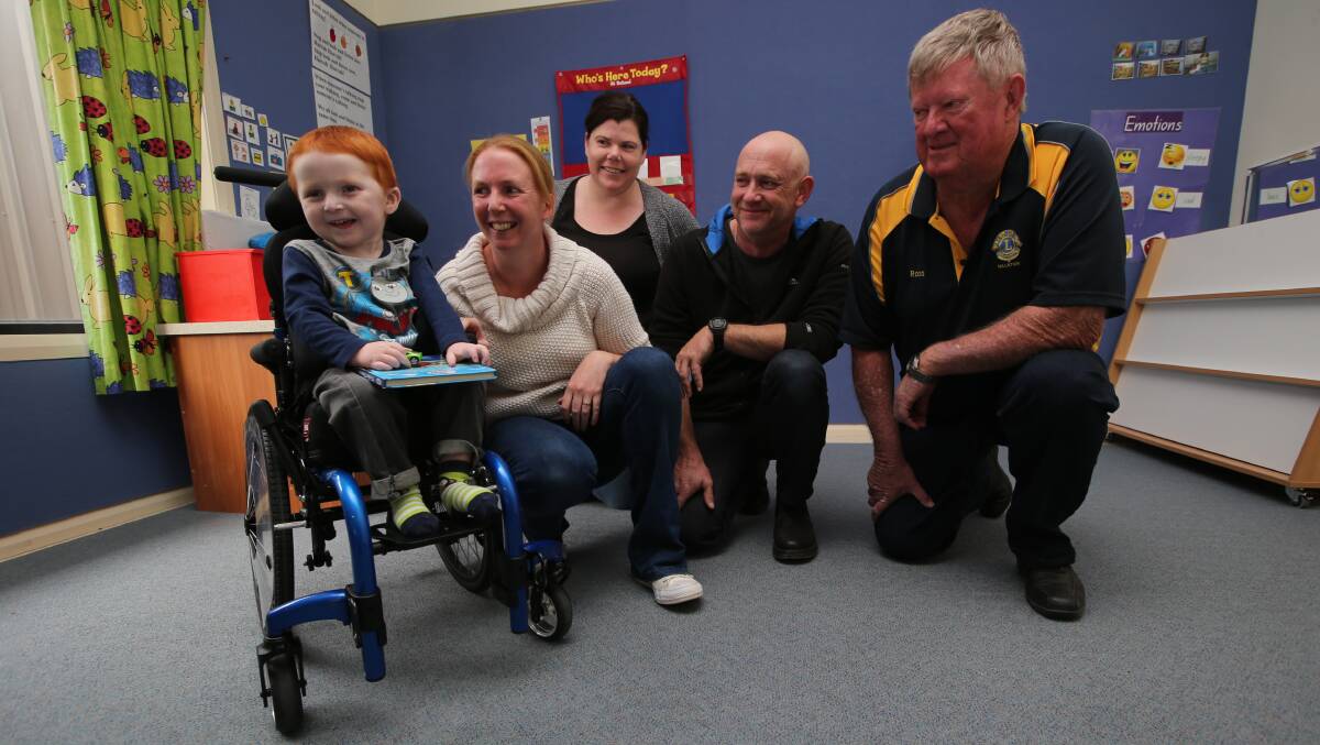 HELPING HANDS: Adam Taylor, 3, in his new wheelchair from funds raised by the Hillston Lions Club with each dollar matched by the ACT public health fund.