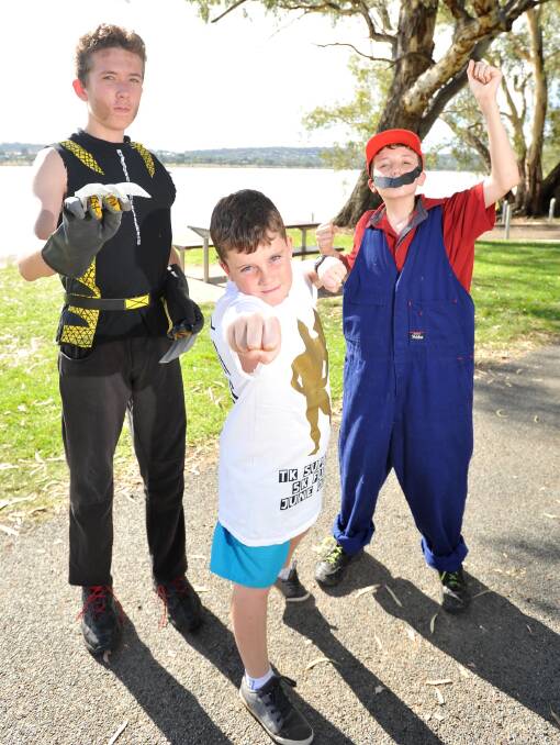 CALL TO ARMS: Adrian Buntin, 12, Will Pike, 10, and Bob Buntin, 11, prepare their best pose for the Autism Superhero Walk at Lake Albert on March 22. Picture: Laura Hardwick