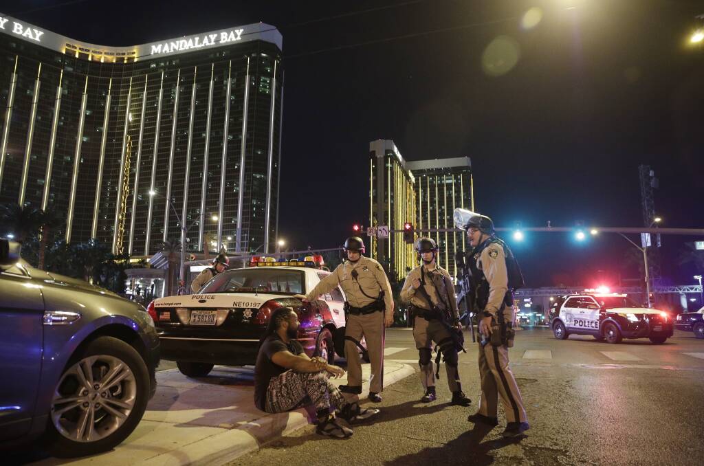 Police in Las Vegas after a shooting that killed almost 60 people and injured thousands more.