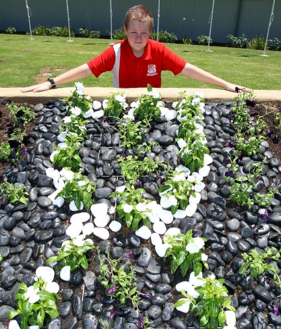 RAISING AWARENESS: Mount Austin Public School student Tyson Reichelt, 11, with the garden to be unveiled today on White Ribbon Day. Picture: Les Smith