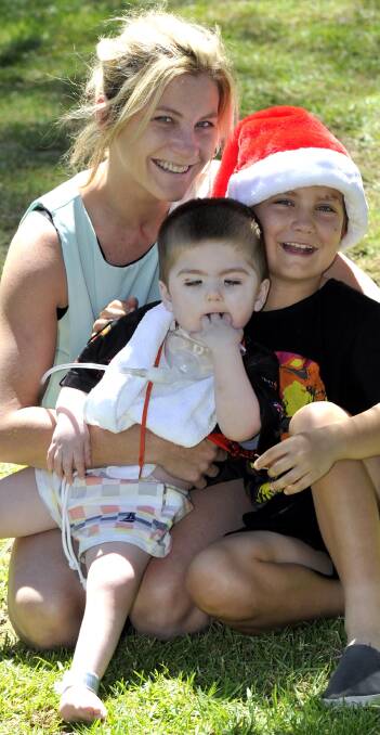 SMILES 4 JACOB: Alissa Heffy with three-year-old Jacob Heffy (centre) and Seth Martin. Picture: Les Smith