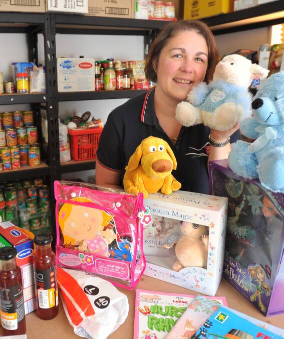 GIVING SPIRIT: Salvation Army minister Bindy Lupis sorts through items already donated. She is looking for more food and toys for the Salvation Army and St Vincent de Paul to give families this Christmas. Picture: Kieren L Tilly