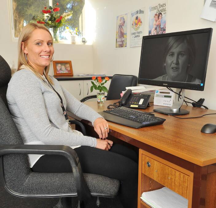 EVERY VOTE COUNTS: Riverina Community College's hair and beauty co-ordinator Mel Livermore watches video of Kellie Exton, Wagga area primary producer, which has been submitted to obtain funding. Picture: Kieren L Tilly