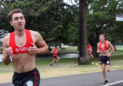 HARD YAKKA: Harry Cunningham (right) trails Dan Robinson in the Swans' three kilometre time trial on Wednesday. Picture: Sydney Swans