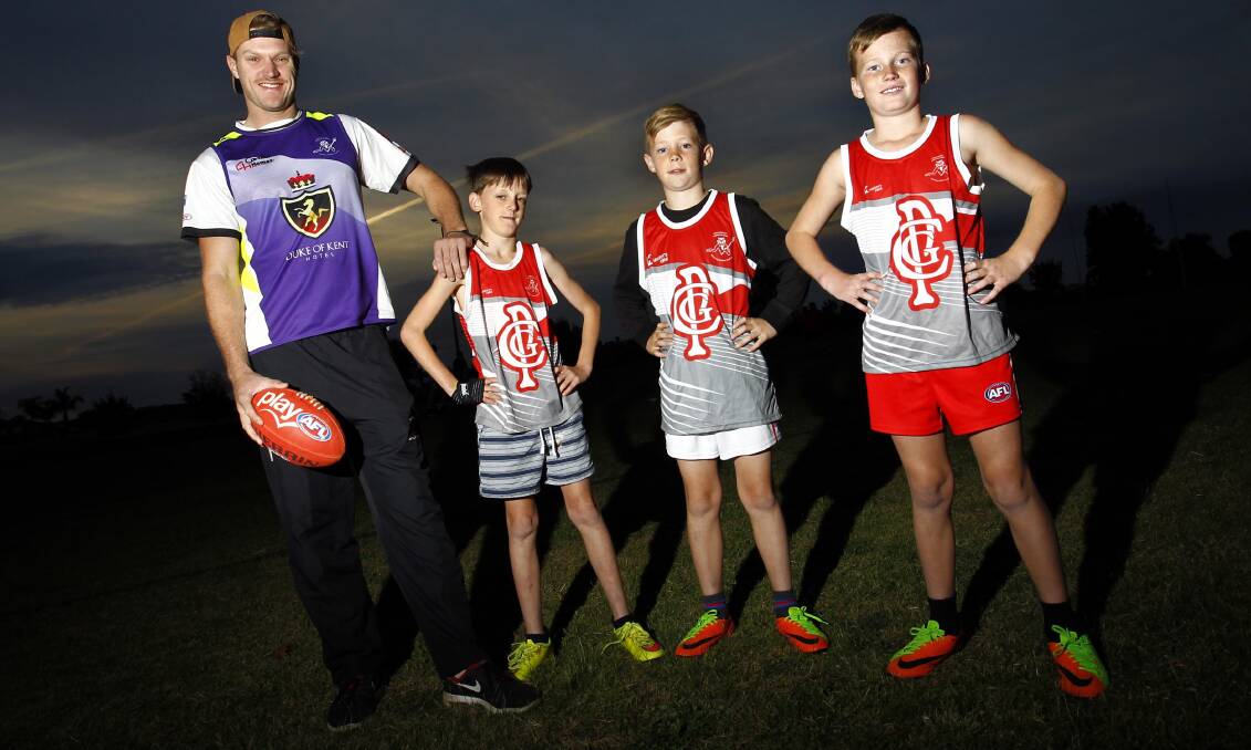 ON THE JOB: Collingullie-Glenfield Park coach Luke Gestier with Tom Woods, 11, Lincoln Bradley, 9, and Seth Clark, 10, at the club's junior training on Wednesday. Picture: Les Smith