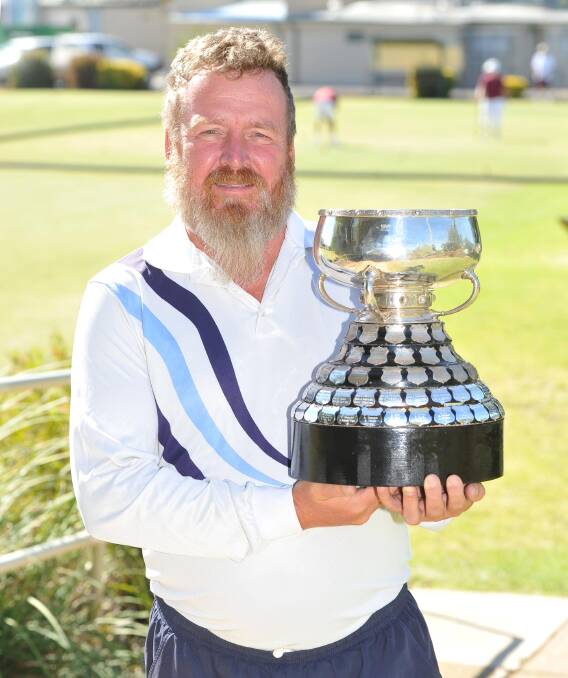 STAR PERFORMER: Wagga croquet player Jim Nicholls shows off the Eire Cup he won with his NSW team at the Australian Croquet Championships. Picture: Laura Hardwick