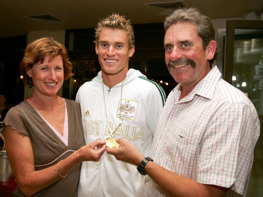 Brad celebrates his Commonwealth Games gold medal with parents Carmel and Paul.