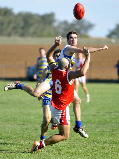 IN DOUBT: Mangoplah-Cookardinia United-Eastlakes' Mitch Daniher punches the ball away from Collingullie's Brad Aiken. Daniher hopes to return for Saturday's second semi-final.