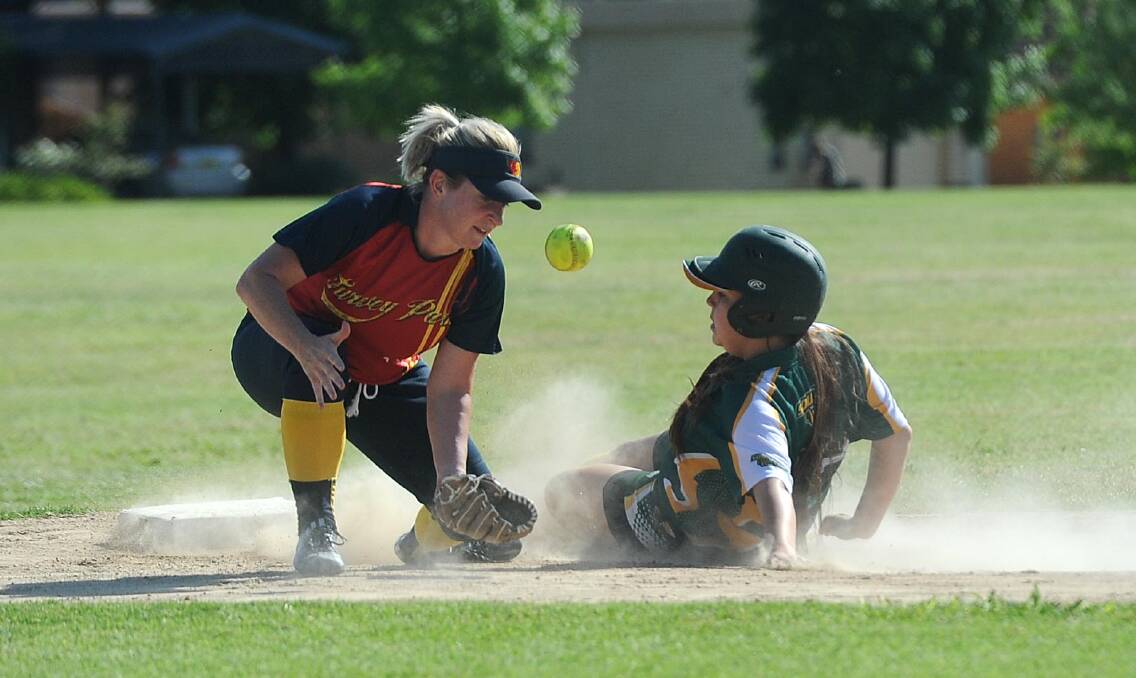 CLOSE CALL: Turvey Park's Kayla Armstrong looks to take the ball as South Wagga's Jayla Nix dives into base. Turvey Park's fielding errors have been costing them wins. Picture: Laura Hardwick