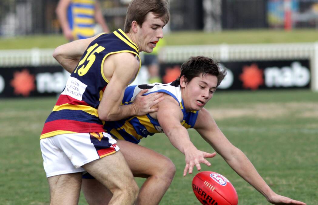 COME HERE: MCUE's Theo Metcalfe looks to gather the ball in front of Leeton-Whitton's Jayden Lehman at Robertson Oval on Saturday. Picture: Les Smith