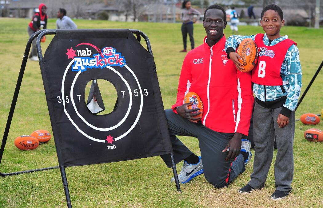 SPECIAL VISIT: Sydney Swans' Aliir Aliir with talented Wagga athlete Frankleen Newah Jarfoi at French Fields in Wagga on Thursday. Picture: Kieren L Tilly