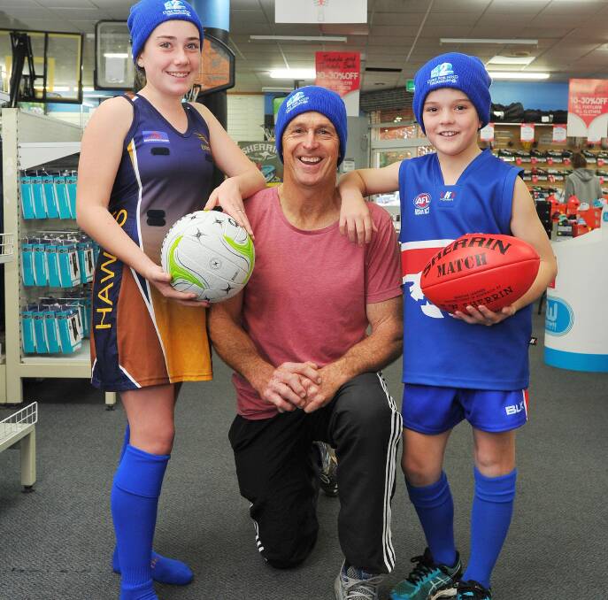 BOLD IN BLUE: East Wagga-Kooringal's Amy Leddin, 12, Chris Daniher, and Turvey Park's Preston Schultz, 9, prepare for 'Sock it to MND' round on Sunday. Picture: Kieren L Tilly