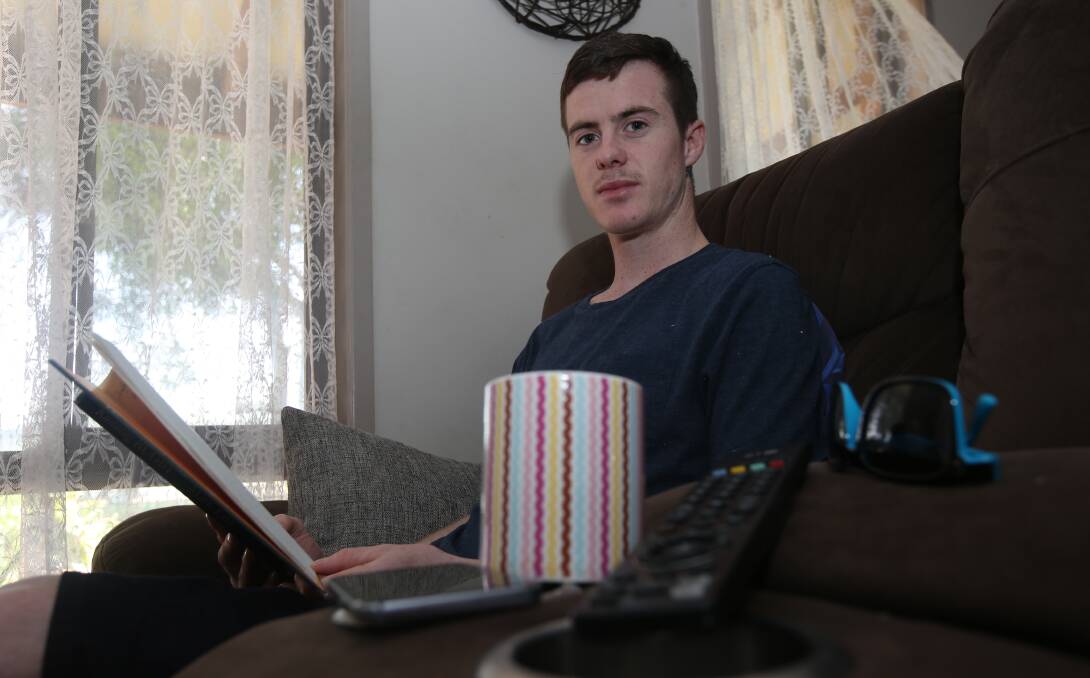 ROAD TO RECOVERY: Injured jockey John Kissick relaxes at home in Griffith after breaking his back riding a steer. Picture: Anthony Stipo