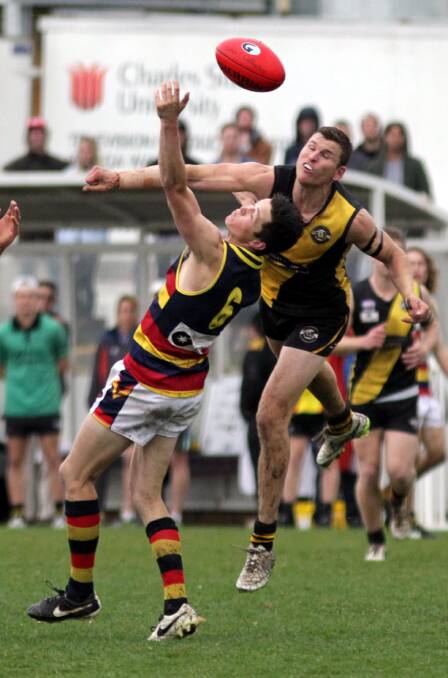GREAT BATTLE: Leeton-Whitton's Luke Potter contests with Wagga Tigers' Dale Walker in the Riverina League grand final at Robertson Oval. Pictures: Les Smith