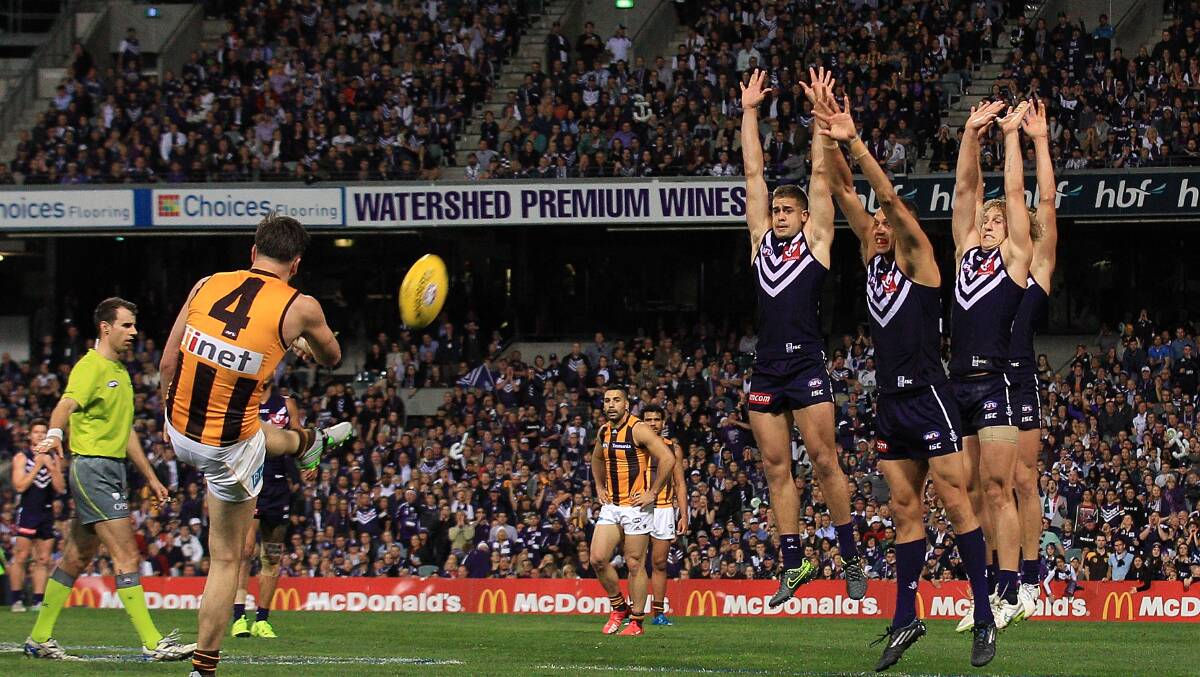 SPECIAL MOMENT: Matt Suckling launches a huge goal after the three-quarter-time siren in Friday night's preliminary final win over Fremantle.