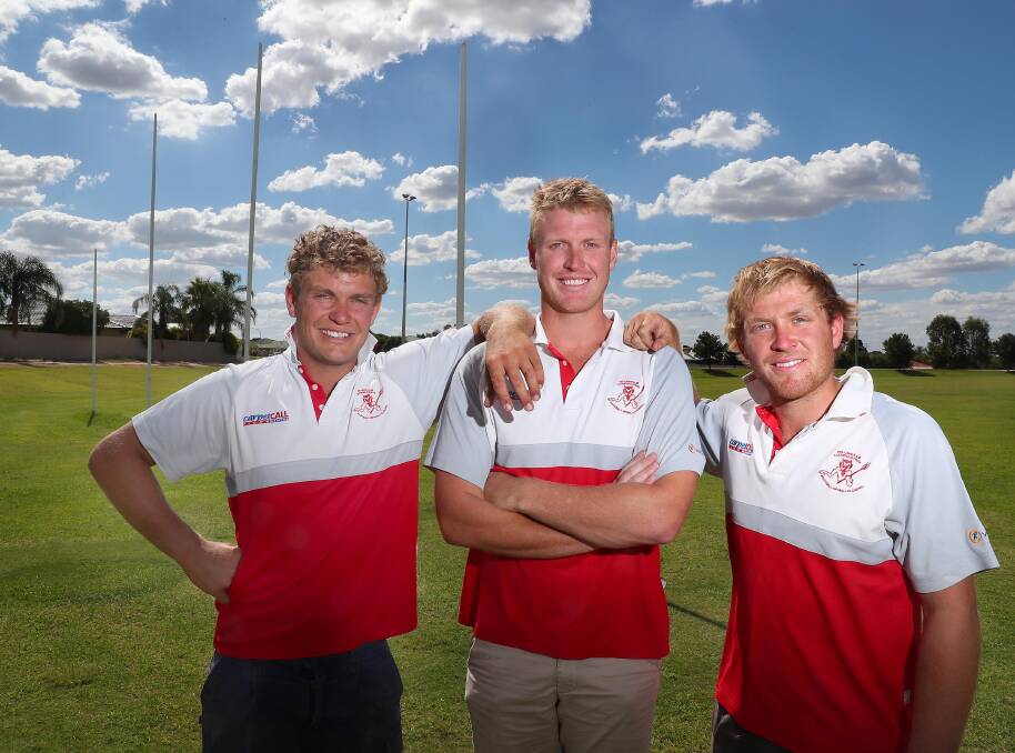 BROTHERS IN ARMS: Ben Klemke (middle) is welcomed to Collingullie-Glenfield Park by brothers Jayden (left) and Matt (right) on Friday. Picture: Kieren L Tilly