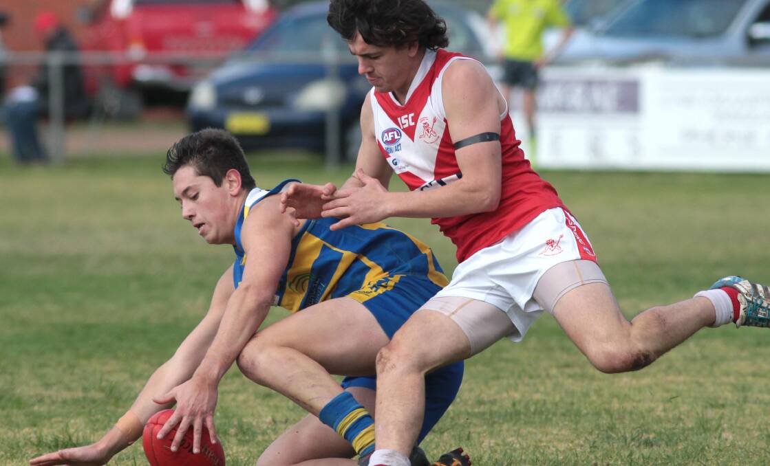 FIRST IN: MCUE's Theo Metcalfe beats Collingullie's Daniel Kennedy to the ball at Mangoplah Sportsground on Saturday. Picture: Les Smith