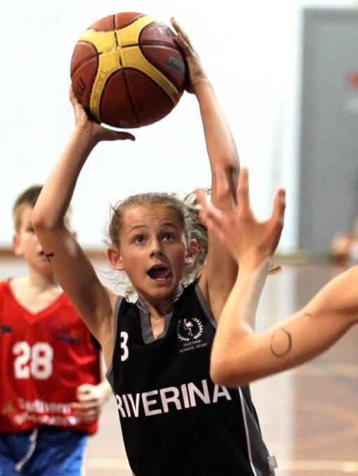 EYE ON THE PRIZE: Samantha Graham, 12, in action during the Southern Sports Academy basketball trials at Bolton Park on Sunday. Picture: Les Smith